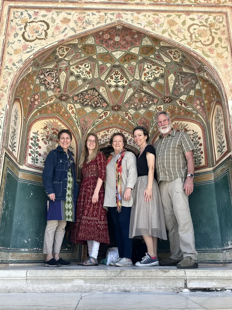 A group of travellers at a painted gate of Amber Fort