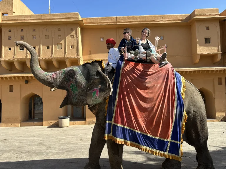 Travellers riding an elephant up to Amber Fort, Jaipur, on a Golden Triangle tour
